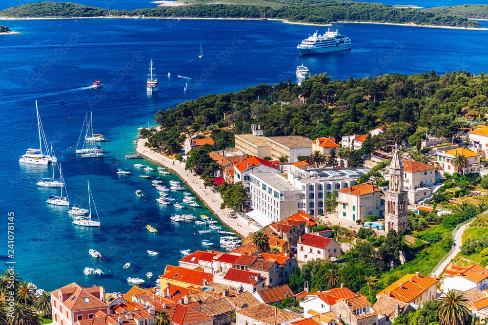 View at amazing archipelago with boats in front of town Hvar, Croatia. Harbor of old Adriatic island town Hvar. Popular touristic destination of Croatia. Amazing Hvar city on Hvar island, Croatia.