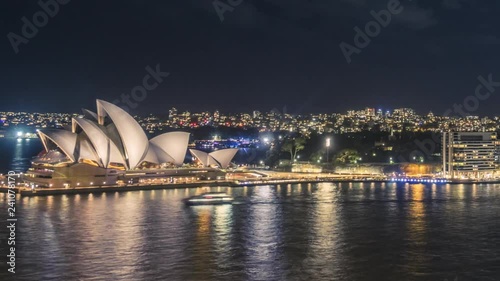 Iconic Sydney Opera House at night with buzzing Sydney Harbour in timelapse video.