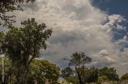 Threatening summer storm clouds gather above a residential area on the Gauteng Highveld in South Africa image with copy space in landscape format
