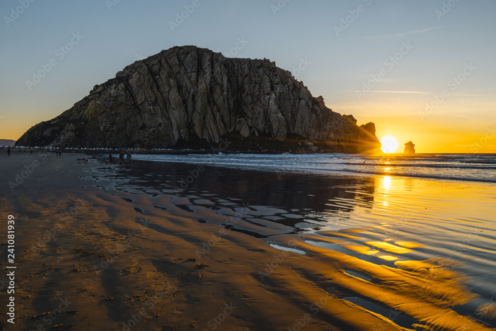 Beautiful sunset on the beach, Morro Rock in Moro Bay, California during sunset