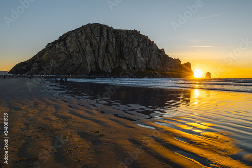Beautiful sunset on the beach, Morro Rock in Moro Bay, California during sunset