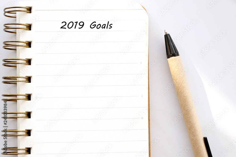 Blank notebook paper and pen on white marble background, with copy space for text, top view Blank notebook paper and pen on white marble background, with copy space for text, top view