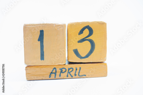 april 13th. Day 13 of month, handmade wood calendar isolated on white background. spring month, day of the year concept.