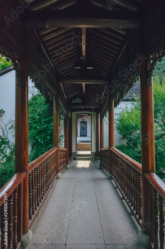 Covered footpath leading to doorway in a traditional Chinese Garden, near West Lake, Hangzhu, China