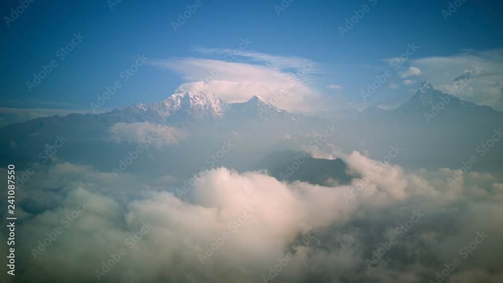 Naklejka premium Orange sunrise above mountain in valley Himalayas mountains