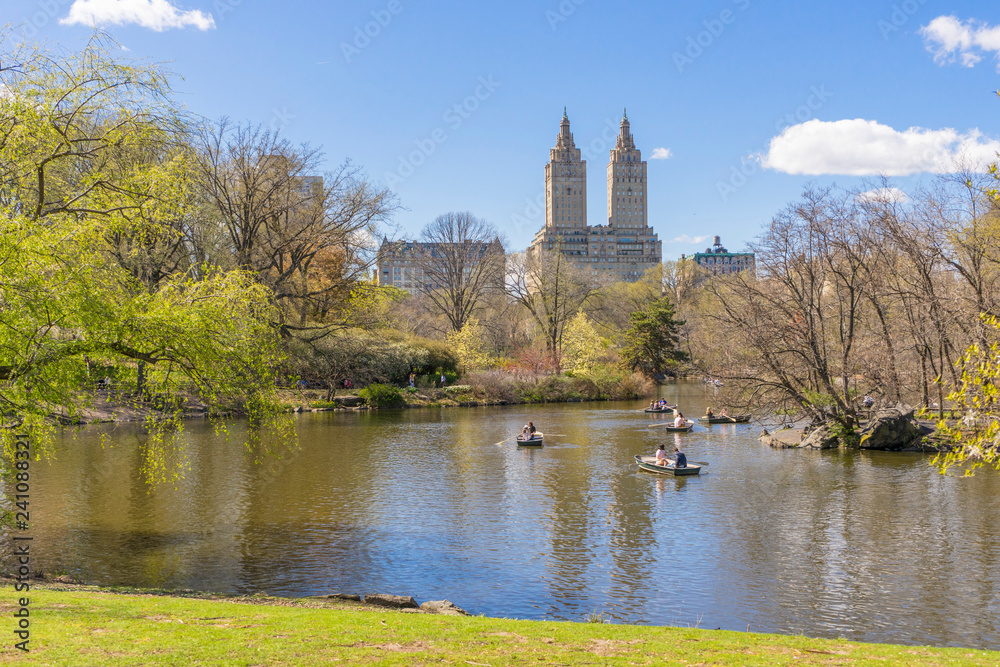People boating in The lake at Central Park on nice weather day in New York City,USA People boating in The lake at Central Park on nice weather day in New York City,USA