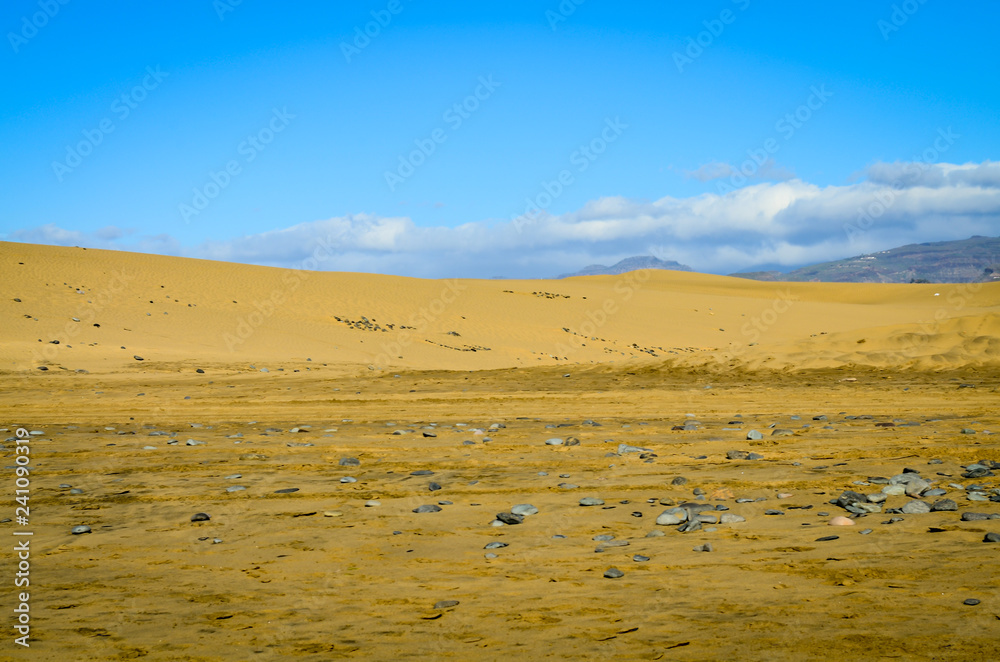 Sand dunes in the desert warm dry sand under blue sky Sand dunes in the desert warm dry sand under blue sky