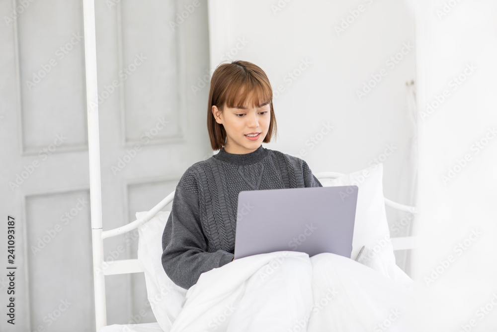 Beautiful Attractive Asian young woman lying on bed and using computer laptop for using social media and shopping online relax in bedroom in holiday,Lifestyle in bedroom Concept Beautiful Attractive Asian young woman lying on bed and using computer laptop for using social media and shopping online relax in bedroom in holiday,Lifestyle in bedroom Concept