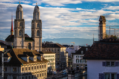 Zurich, Switzerland - view of the Grossmunster church with beautiful mountains in the background