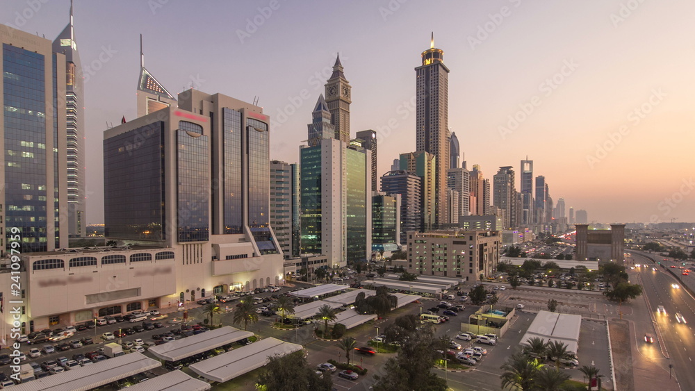 Obraz premium Downtown Dubai towers day to night timelapse. Aerial view of Sheikh Zayed road with skyscrapers after sunset.