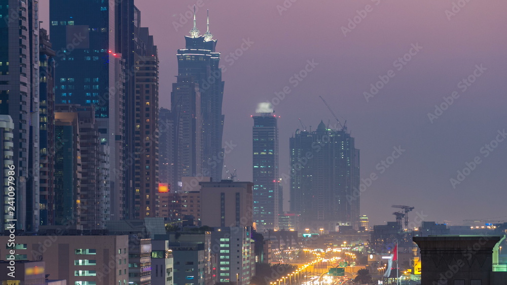 Obraz premium Downtown Dubai towers day to night timelapse. Aerial view of Sheikh Zayed road with skyscrapers after sunset.