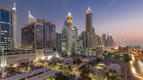 Downtown Dubai towers day to night timelapse. Aerial view of Sheikh Zayed road with skyscrapers after sunset.