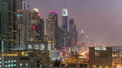 Downtown Dubai towers day to night timelapse. Aerial view of Sheikh Zayed road with skyscrapers after sunset.