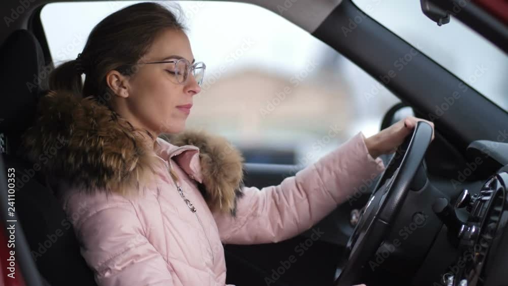 Portrait of a girl with glasses who is driving a car, she turns off the car and goes out 4K Slow Mo Portrait of a girl with glasses who is driving a car, she turns off the car and goes out 4K Slow Mo