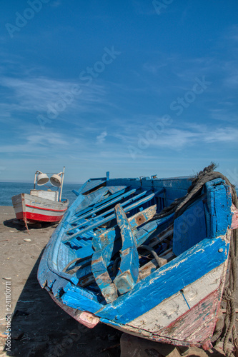 Small fishing boats stranded on the beach of Oued Laou, a village in the province of Chefchaouen on the Mediterranean coast of Morocco. © juanorihuela