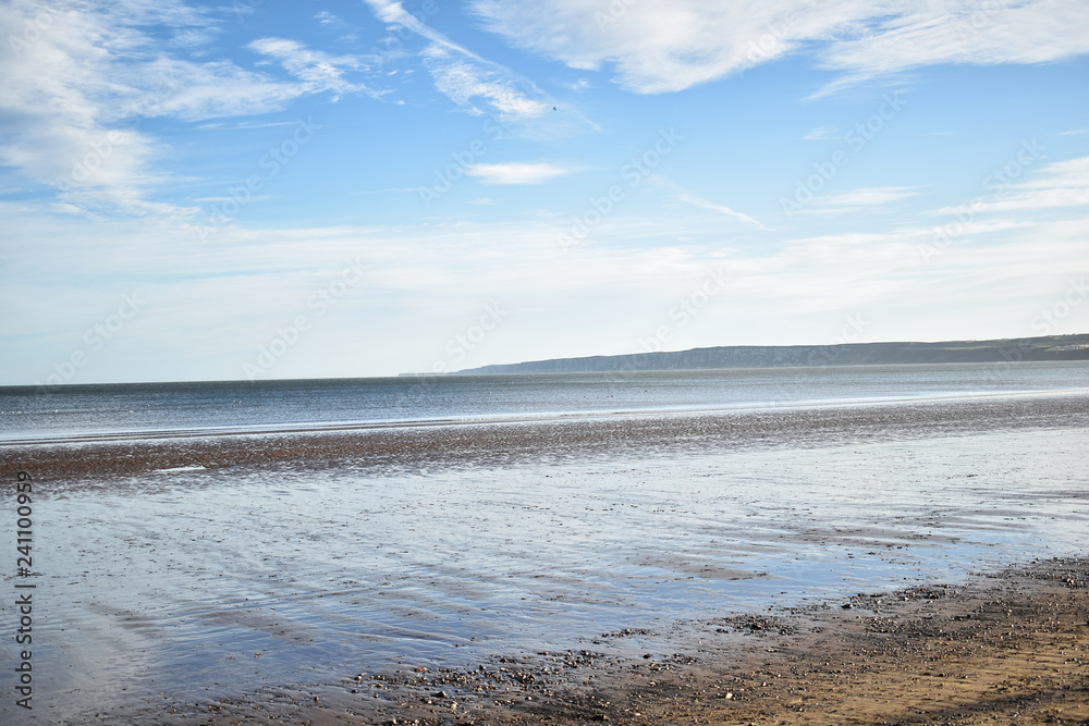 reflection of sky on beach