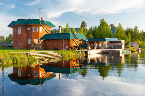 Mansion on the lake. Brick residential building in a picturesque location
