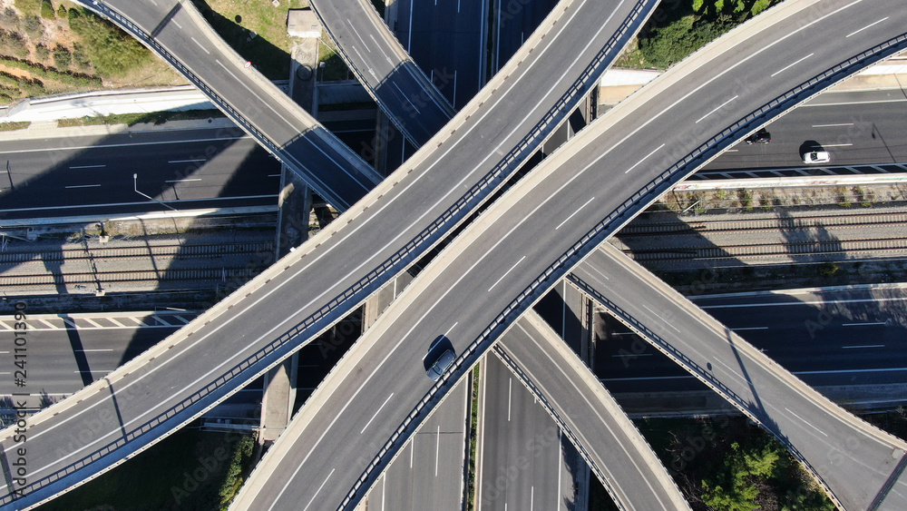 Aerial photo of multilevel elevated highway junction highway passing through modern city in multiple directions Aerial photo of multilevel elevated highway junction highway passing through modern city in multiple directions