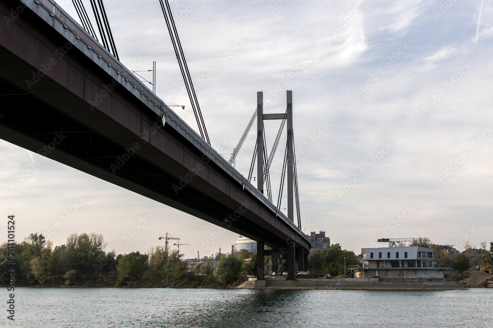 Fototapeta premium Riverside view, boat, river, bridge