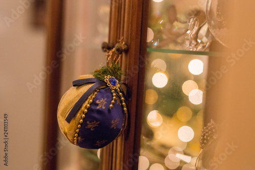 Wallpaper Mural horizontal image with a close-up detail of a Christmas ball re-issued in blue and gold-colored fabric hanging from a knob Torontodigital.ca