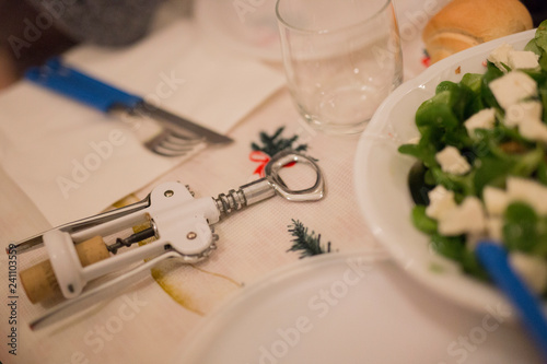 Wallpaper Mural horizontal image with a close-up detail of a white corkscrew laid on a table during a lunch Torontodigital.ca