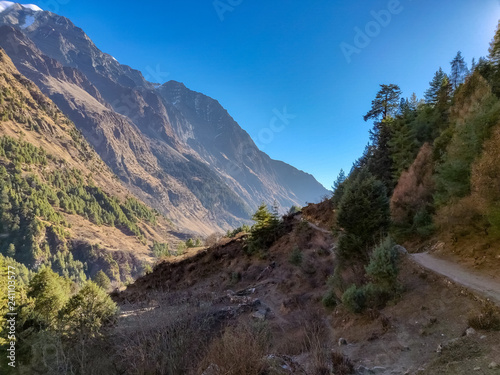 Narrow trekking trail on the ridge of a mountain in Nepal. Manaslu Conservation Area
