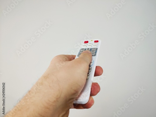 left hand holding remote control