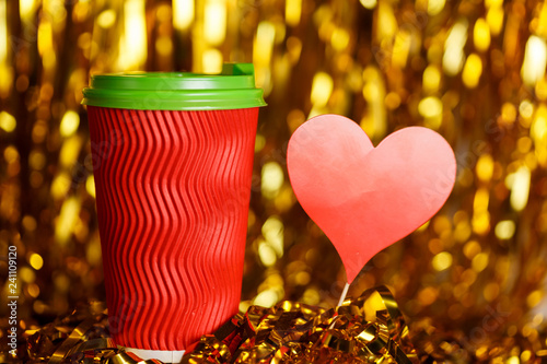 Coffee in red cup with red heart and Christmas golden metafan photo