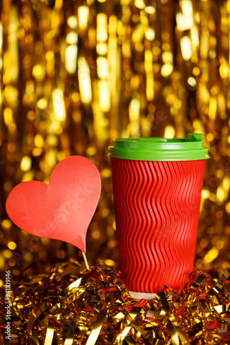 Coffee in red cup with red heart and Christmas golden metafan photo