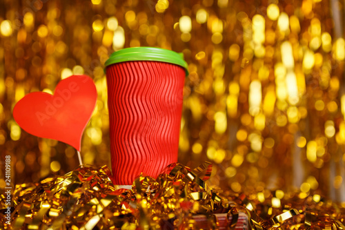 Coffee in red cup with red heart and Christmas golden metafan photo