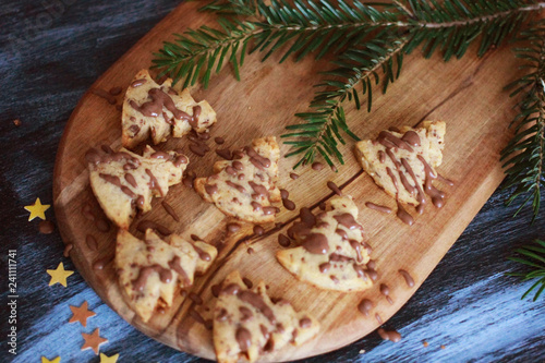 Christmas pastry tree with chocolate on wooden baord, close up photo