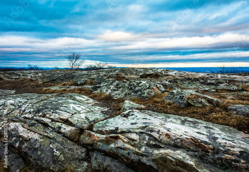 Rocky granite outcroppings under a beautiful blue cloudy sky at dusk, High Point Monument at the top of NJ in winter