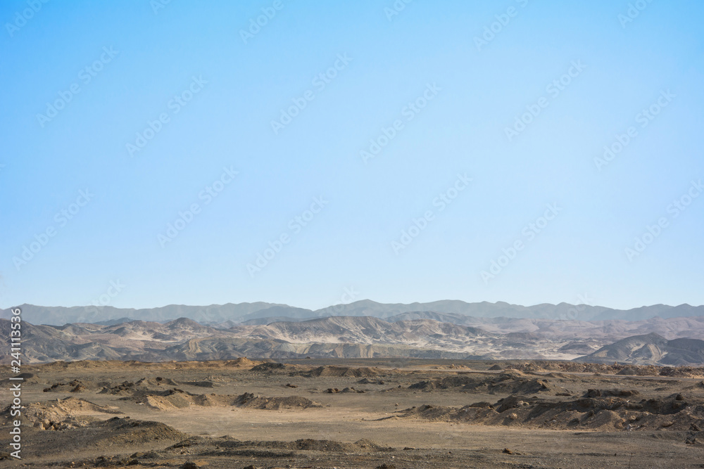 Dry egyptian desert landscape under blue sky
