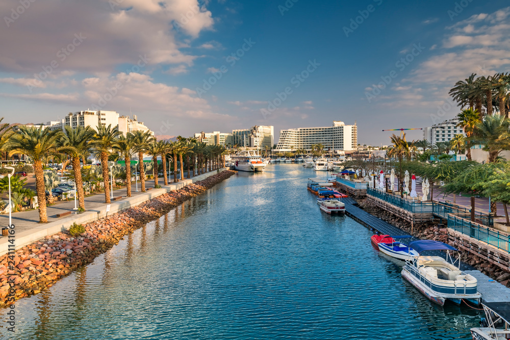 Central marine and promenade with pleasure boats,  surrounding hotels, market and shopping places in Eilat - famous resort and recreational city in Israel and Middle East