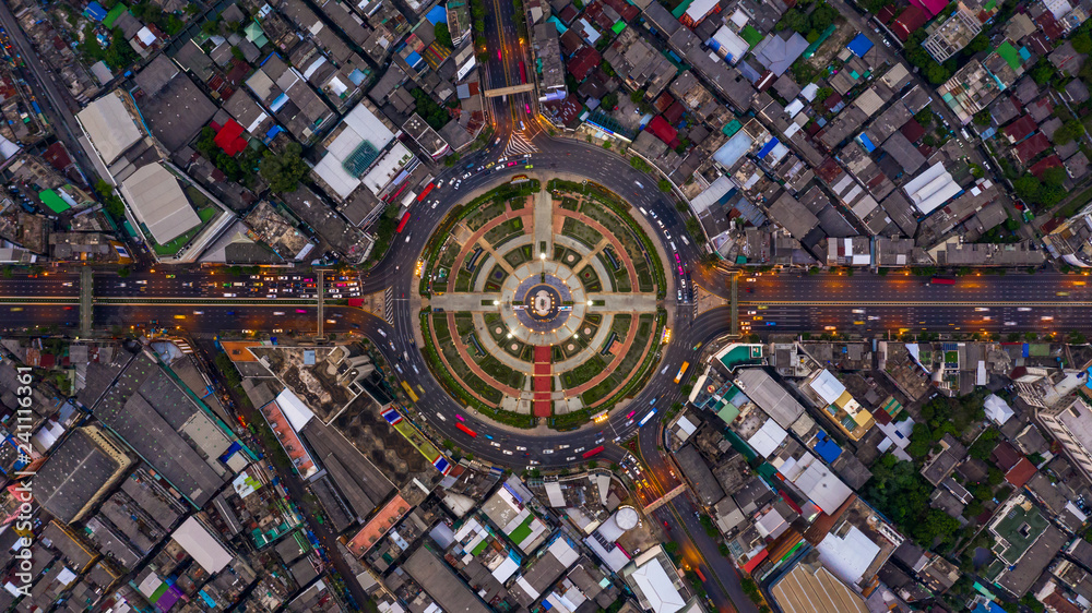 Road roundabout with car lots, road traffic in Bangkok city at night, Aerial top view, Wongwainyai, Bangkok, Thailand.