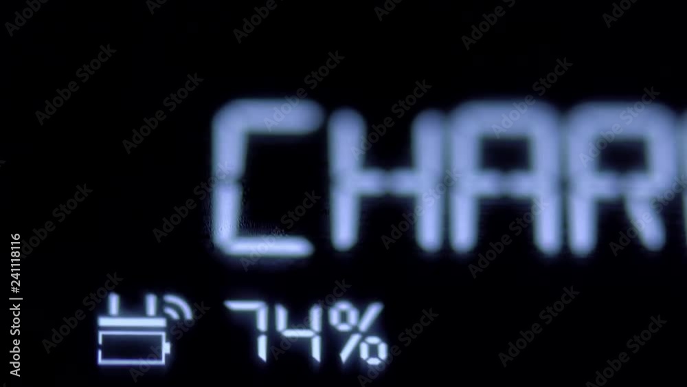 Closeup view of smartphone display with charging battery status icon. Shot in 4k resolution Closeup view of smartphone display with charging battery status icon. Shot in 4k resolution