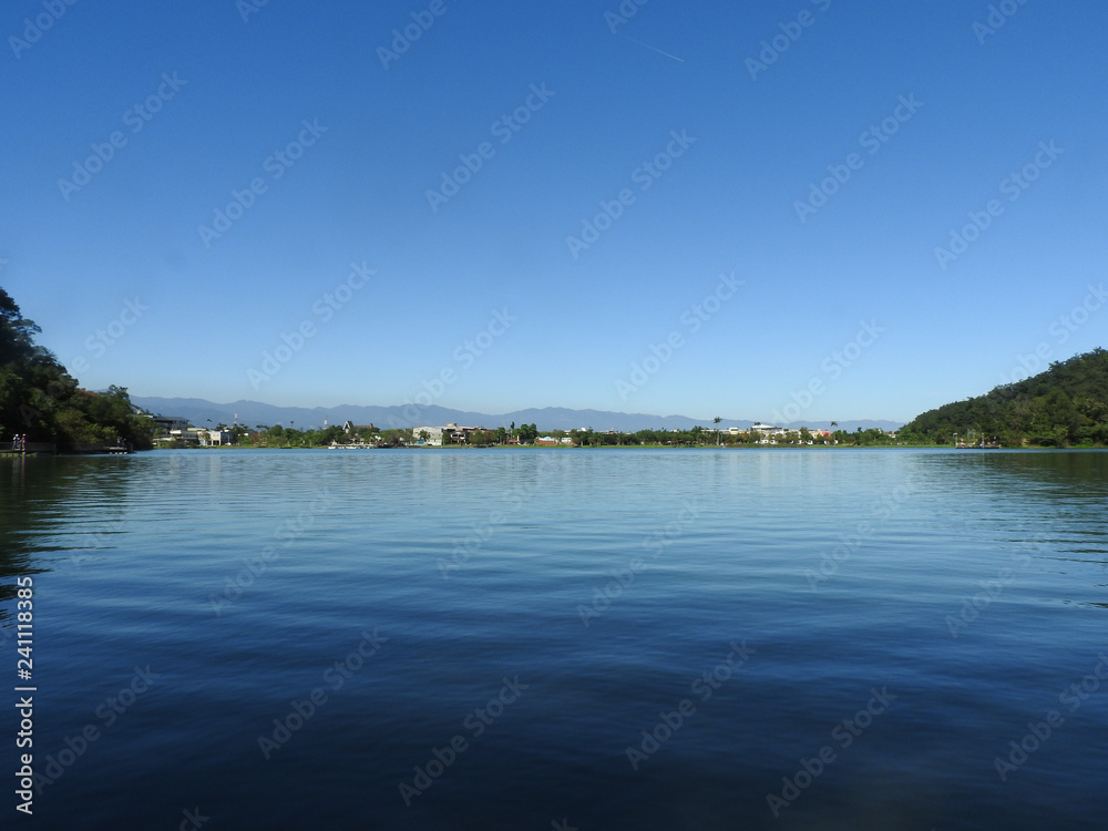 Plum Blossom Lake (Meihua Lake) located at Yilan county, Taiwan. Famous tourist spot for vacation. A natural reservoir.  Blue sky and lake , nature scenery. Feel relaxed and calm. Landscape background