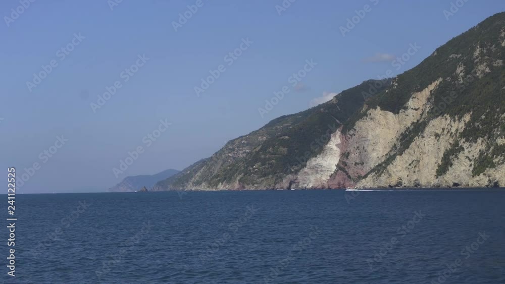 Ship sailing close to shore, Tall white sand mountains in the background. Sunny day Ship sailing close to shore, Tall white sand mountains in the background. Sunny day