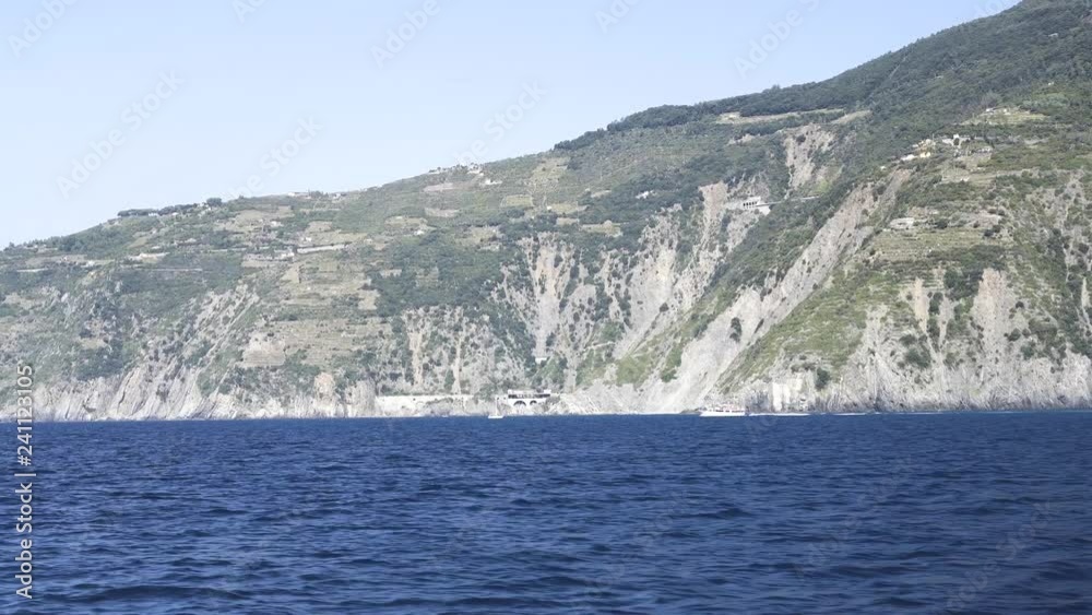 Ship sailing close to shore, Tall white sand mountains in the background. Sunny day Ship sailing close to shore, Tall white sand mountains in the background. Sunny day