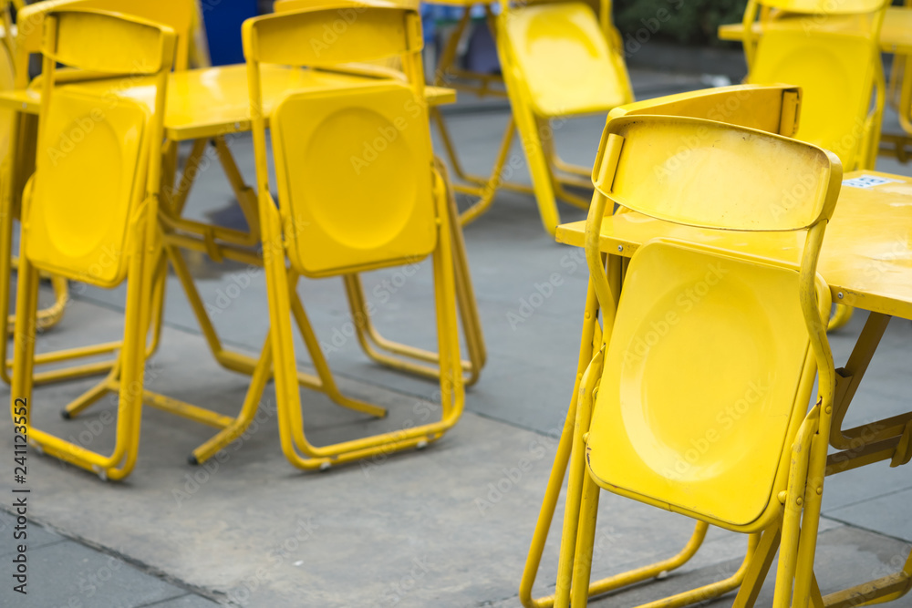 Fototapeta premium Yellow steel chair at outdoor restaurant or beer garden