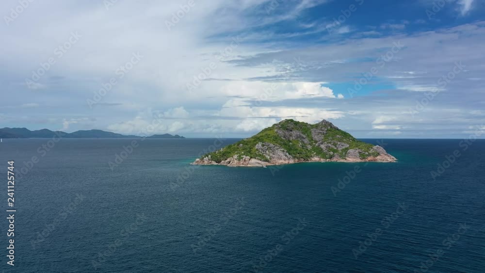 Aerial view of rocky islet Petite Soeur, crystal clear waters of Indian Ocean - seascape of Seychelles islands from above Aerial view of rocky islet Petite Soeur, crystal clear waters of Indian Ocean - seascape of Seychelles islands from above