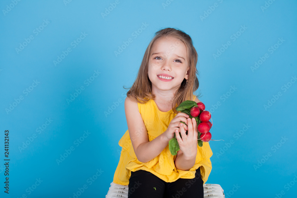 small beautiful girl holding a fresh radish healthy food small beautiful girl holding a fresh radish healthy food