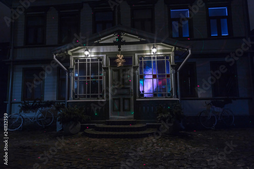 house lit with bright lights at night