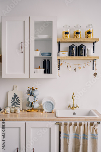 The interior of the bright kitchen in the Scandinavian style