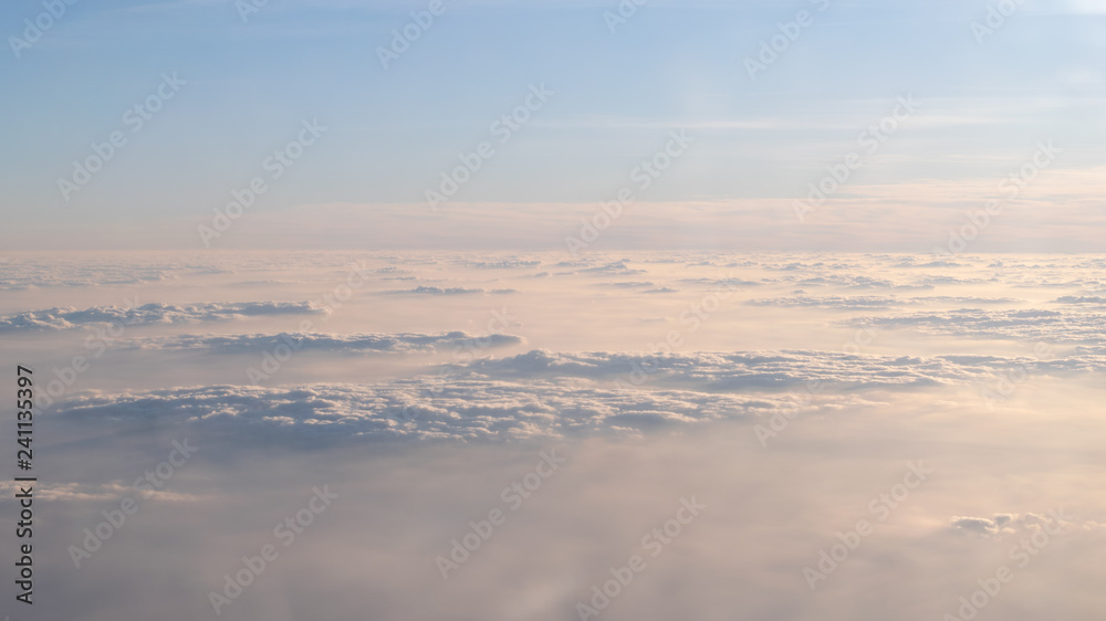 Image of Sunrise above the clouds from airplane window, India