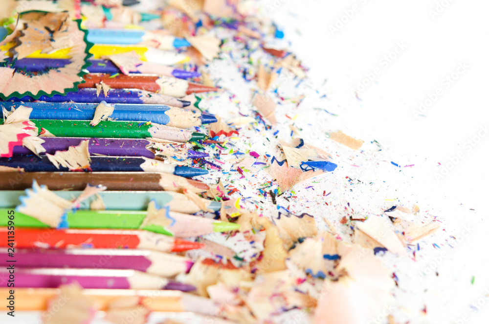 Drawing tools background. Lot of colorful pencils frame with sawdust and shavings on white, copy space, flat lay Drawing tools background. Lot of colorful pencils frame with sawdust and shavings on white, copy space, flat lay
