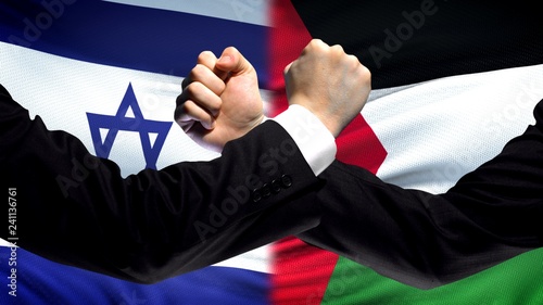 Israel vs Palestine confrontation, religious conflict, fists on flag background