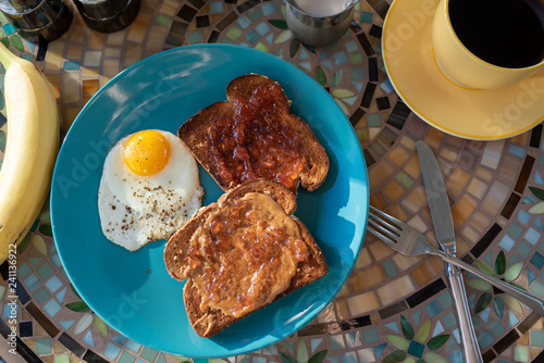 Breakfast meal with coffee, banana, beach plum jelly toast, and egg
