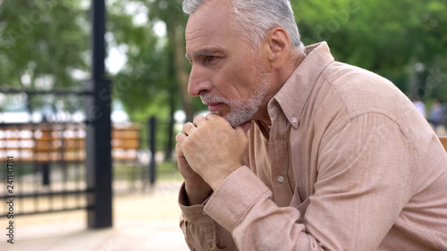 Photography Depressed old male crying on park bench alone, retirement problems, soul pain