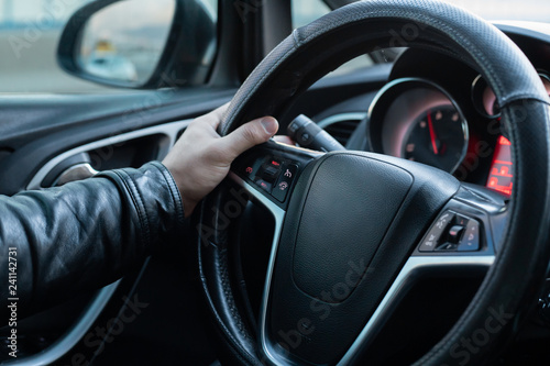 Male driver holding steering wheel while driving © ozencdeniz